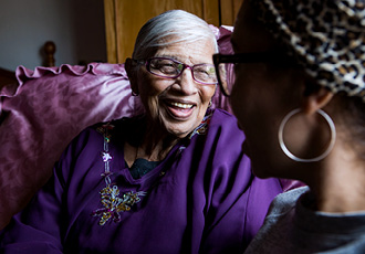 A woman talks with her daughter at home