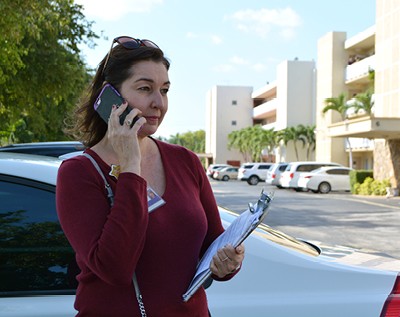 A VITAS team member talks on the phone outside