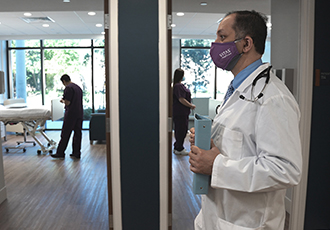 A VITAS physician walks through a hospice inpatient unit