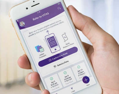 A person uses the VITAS app on a smartphone