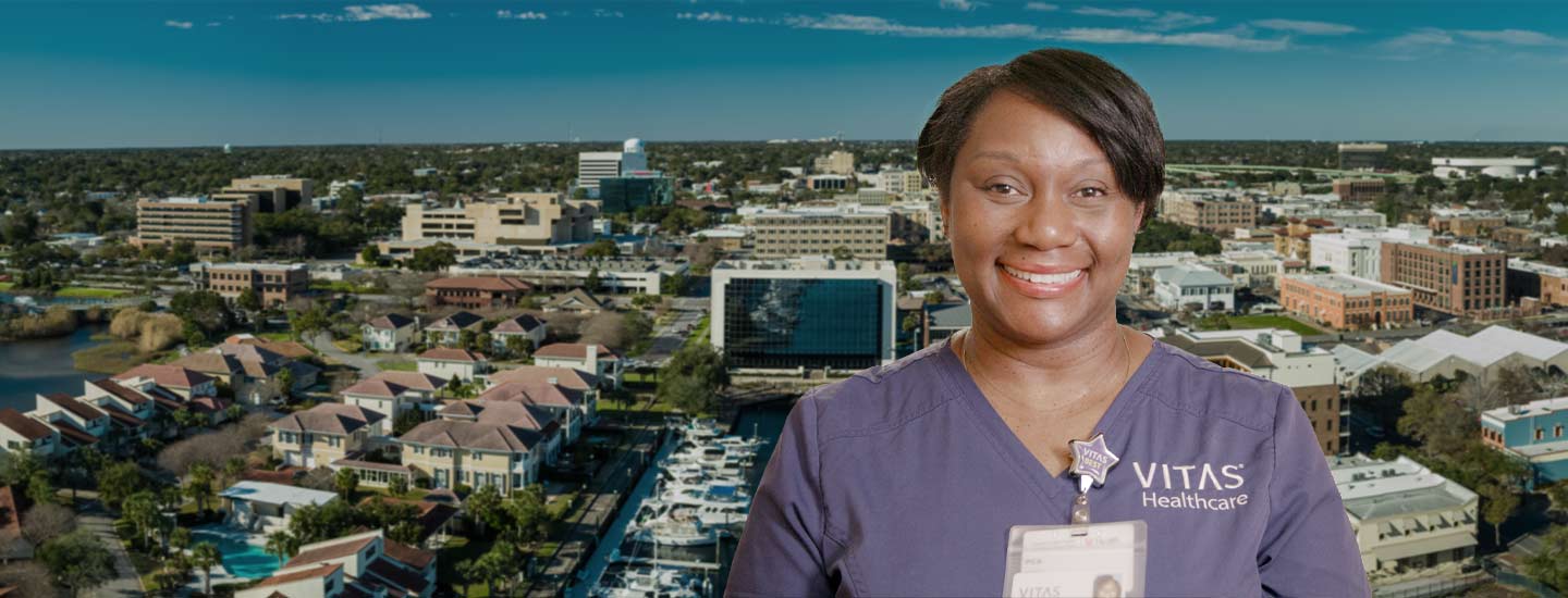 Isang collage ng VITAS nurse sa harap ng skyline ng Pensacola