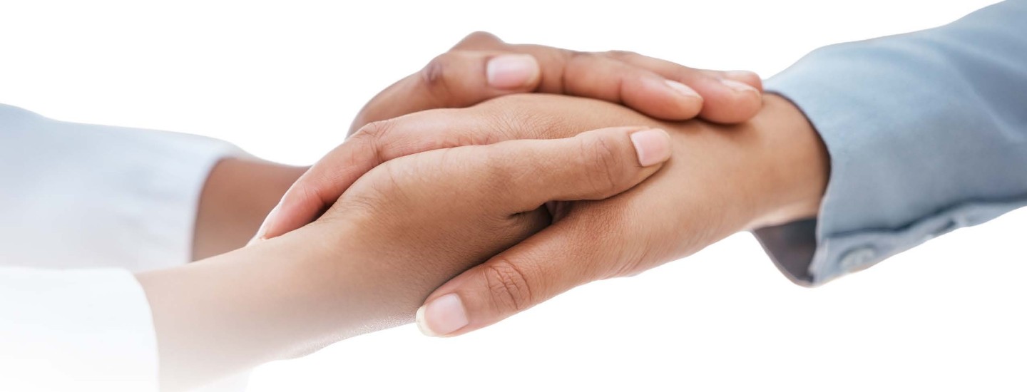 Two people hold hands