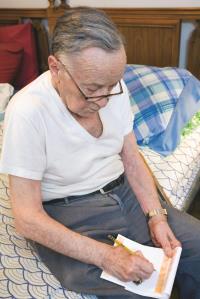 Michael Y. Writing Notes in Journal