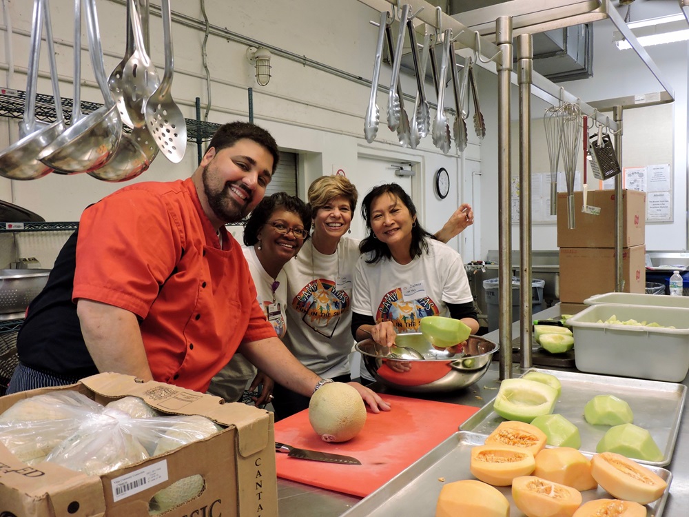 Camp VITAS Chef and volunteers smiling in kitchen