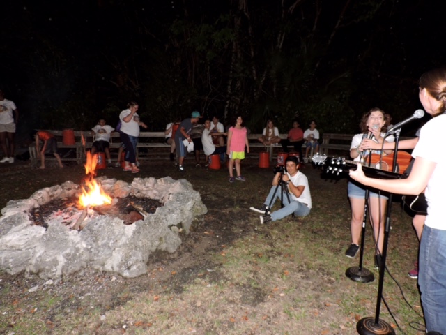 Camp VITAS members singing around a fire