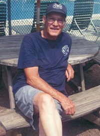 Ed Moore Sitting at wooden table