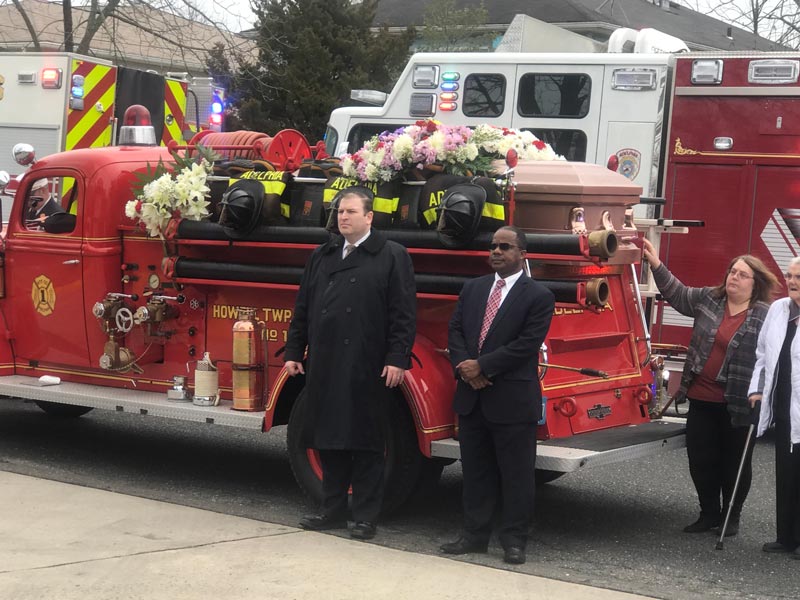 Memorial service for Ed Moore with decorated firetruck