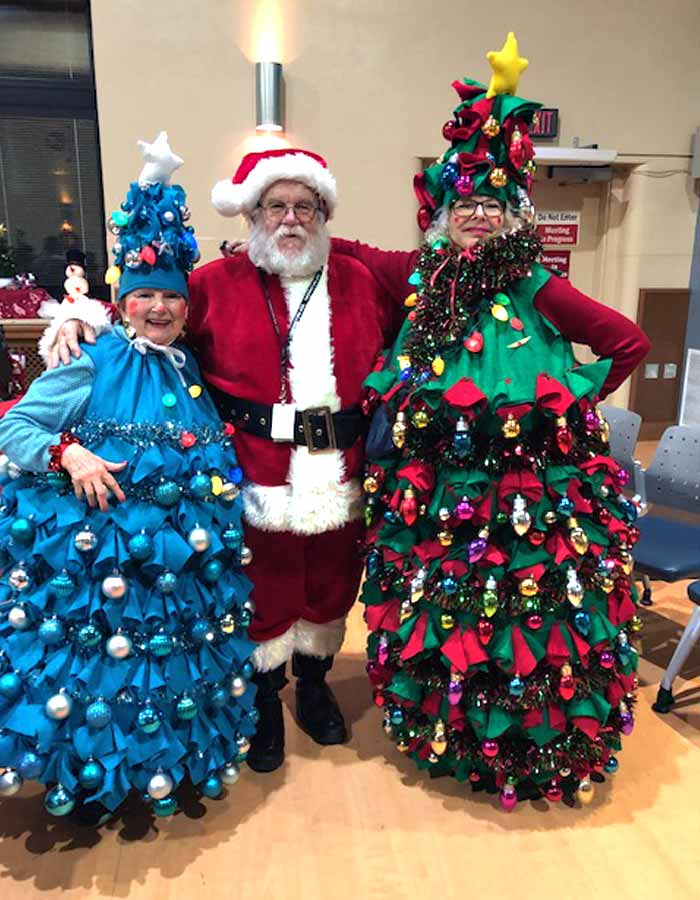 Santa between two Christmas trees