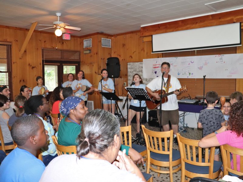 Campers performing a song inside the lodge