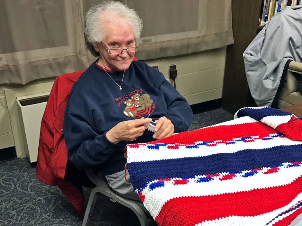 Sewing volunteer Bonnie Weil at work on a blanket