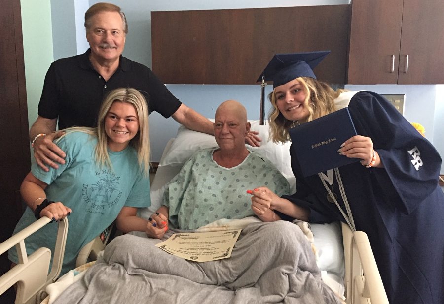 Skyler smiles with her mother, sister and father in her mother's inpatient hospice room