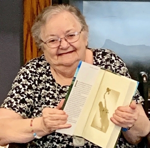 Sandra holds her signed copy of John Grisham's "The Guardians"