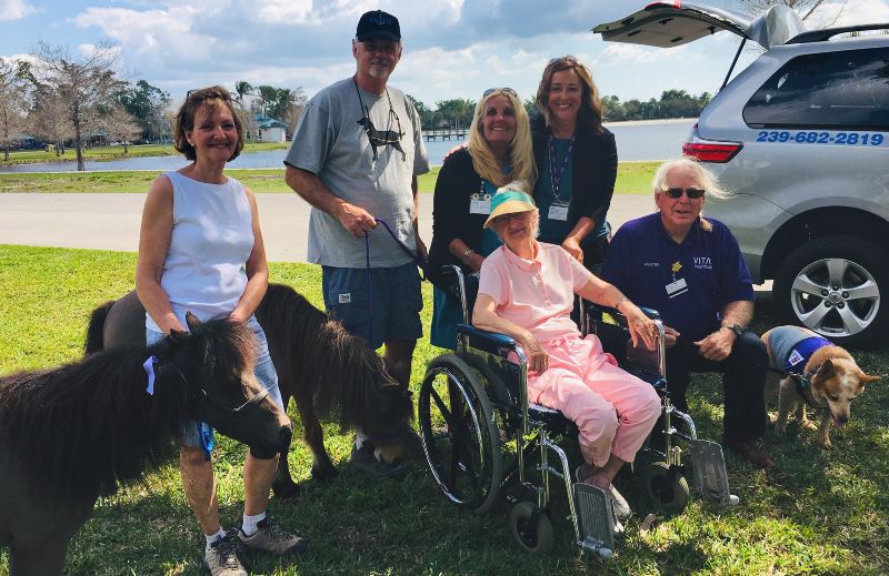 The group gathers with the ponies and a Paw Pals dog