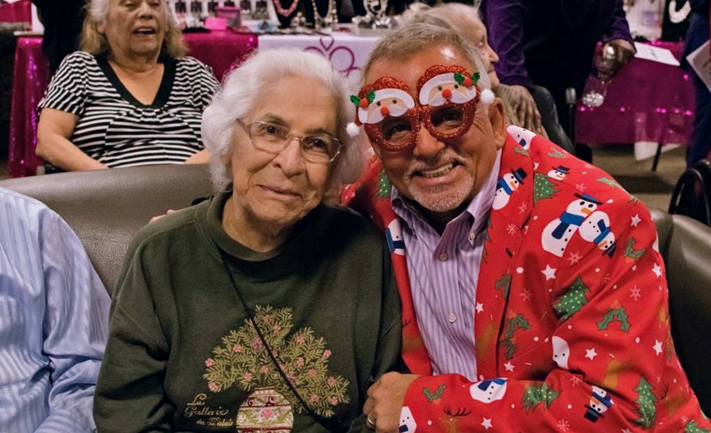 One caroler was decked out in a red holiday blazer with snowmen on it and Santa Claus-decorated glasses