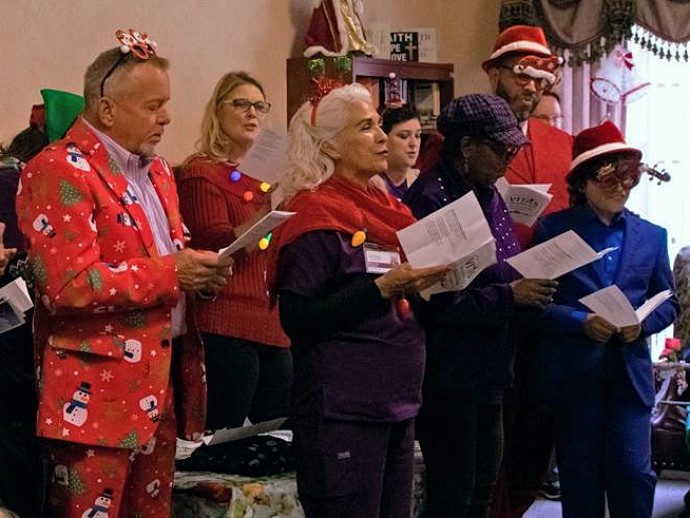 The carolers sing to a group at Senior Care Wurzbach 