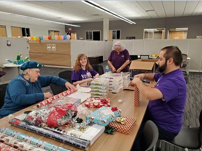 Volunteers wrapping gifts at CASA