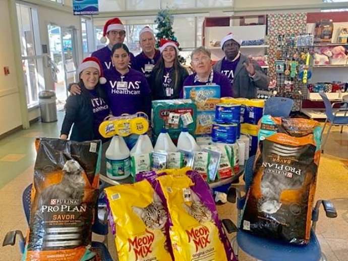 The team with pet food and other supplies they donated to the Humane Society