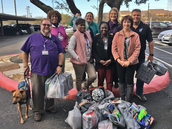 The group with gifts to be donated to children through the Blue Santa program