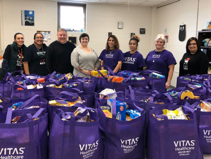 The VITAS team and Winston Elementary staff members with the VITAS bags for students