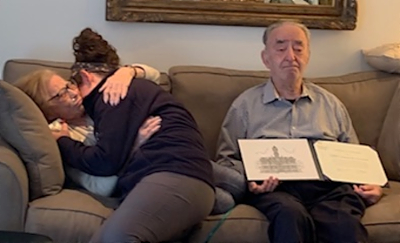 Adele and her granddaughter embrace on the sofa