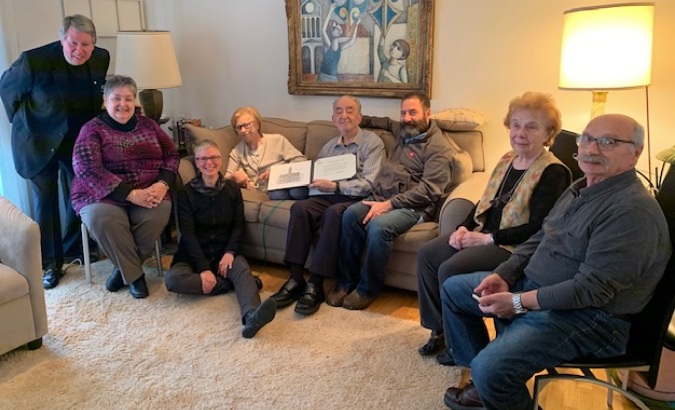 Adele with her award, surrounded by family and Elmhurst College staff