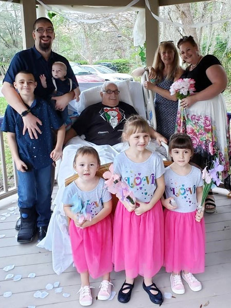 The wedding party poses for a photo in the gazebo, with Philip at center