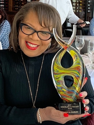 Bailey holds her award