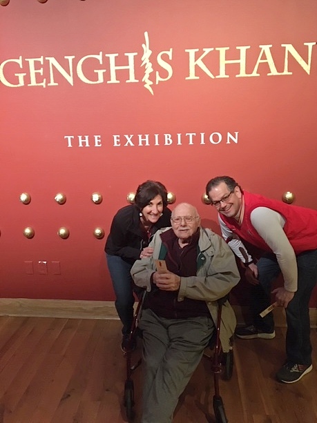 Warner and his tour companions in front of the exhibit sign