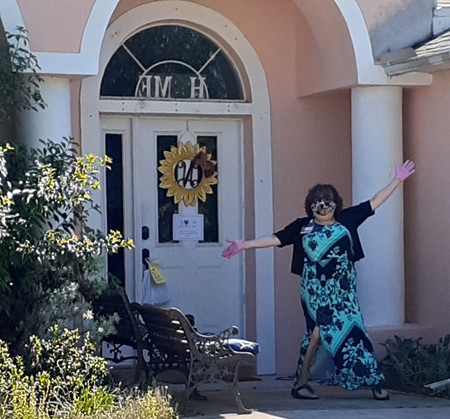 A member of the Brevard team leaves a goody bag on a volunteer's front porch