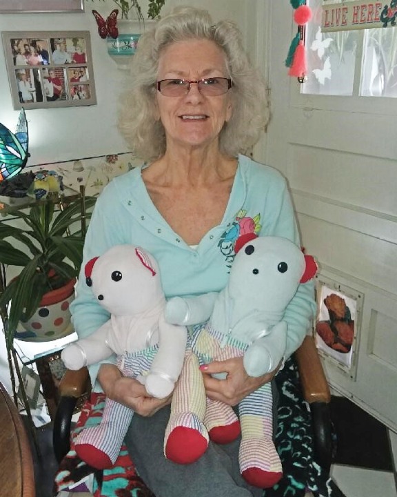 Linda Weeks holds two Memory Bears that a VITAS volunteer crafted from her mother's clothing