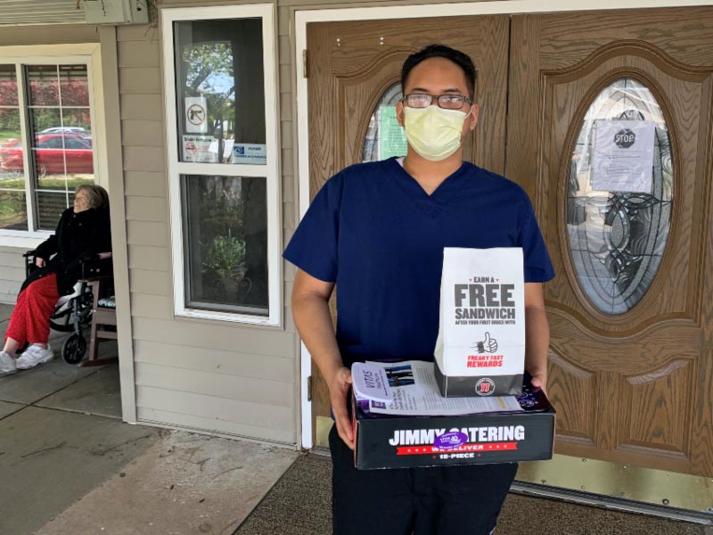 Timothy with a box of sandwiches at the assisted living facility