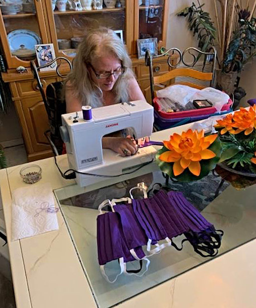 Susan Acocella works at her sewing machine at home