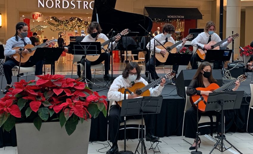 A group of young guitarists performs