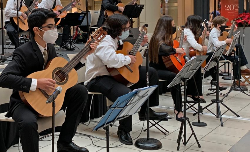 A group of young guitarists performs