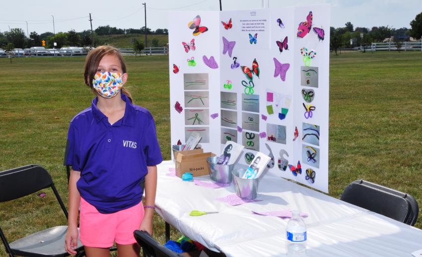 A young volunteer at a table with children's activities