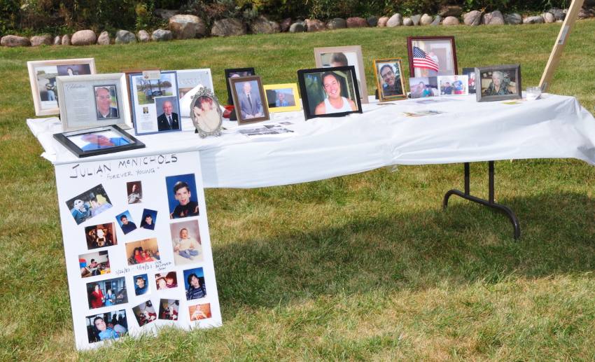 A table with photos of loved ones that families came to remember