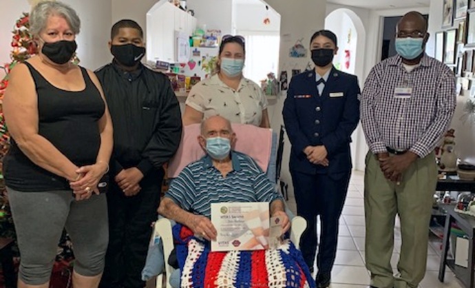 José Pacheco and his family at home with his certificate from VITAS