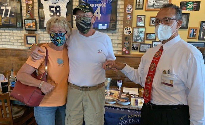 Fred presents a pin to a Vietnam veteran at Mission BBQ
