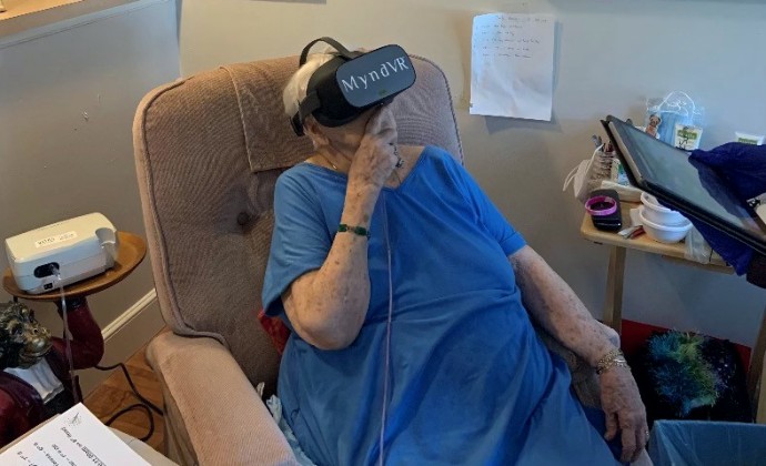 Mary Jean with the VR headset in her armchair