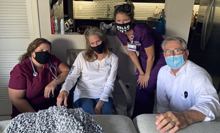 Kim at home surrounded by her hospice care team members