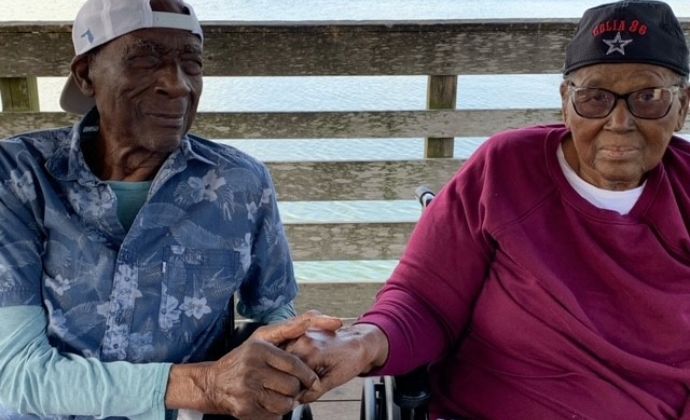 VITAS patient JC Payne and his wife hold hands on the fishing dock