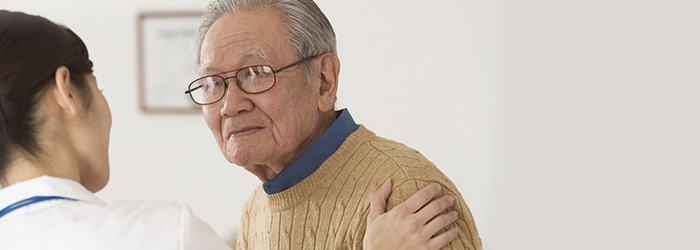 Healthcare professional speaking to patient