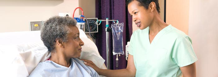 Healthcare professional with bedridden patient