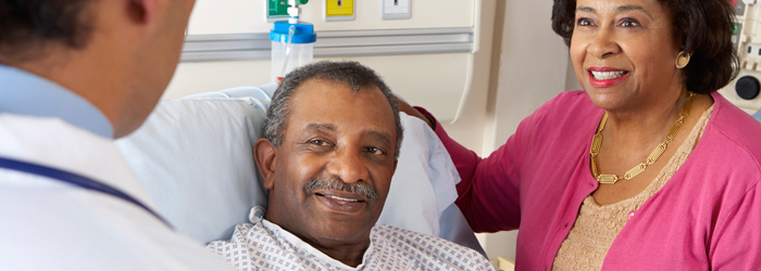 Patient and wife smiling at caretaker