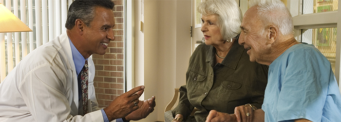 Physician explains something to patient and wife