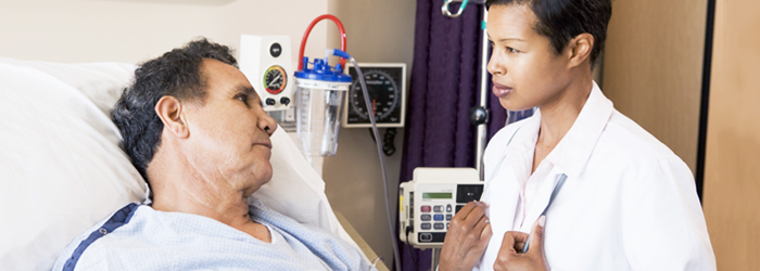 Healthcare professional comforting bedridden patient