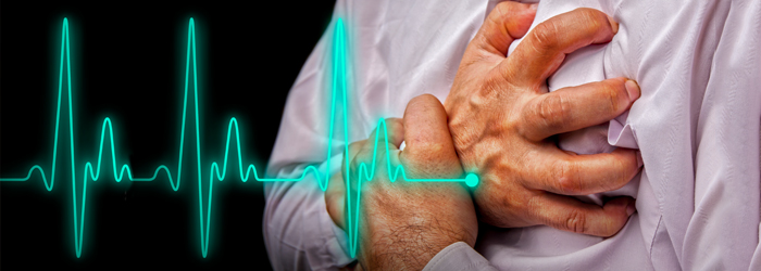 Heart monitor and man grabbing his chest