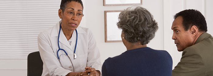 Physician discusses needs with patient and husband