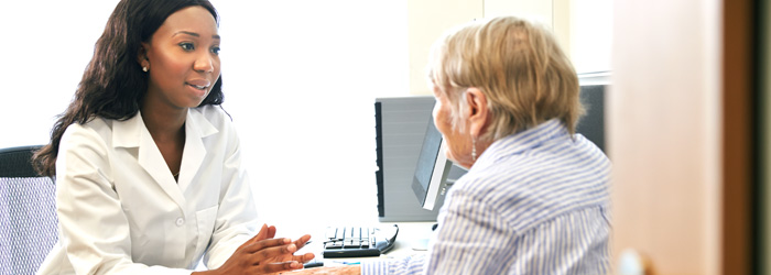 Physician in her office talking to patient