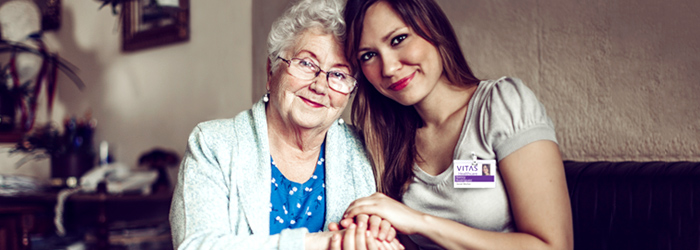 Patient and VITAS caretaker embracing each other